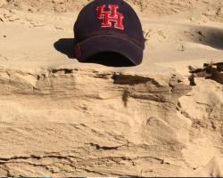 UH hat in Galveston sand